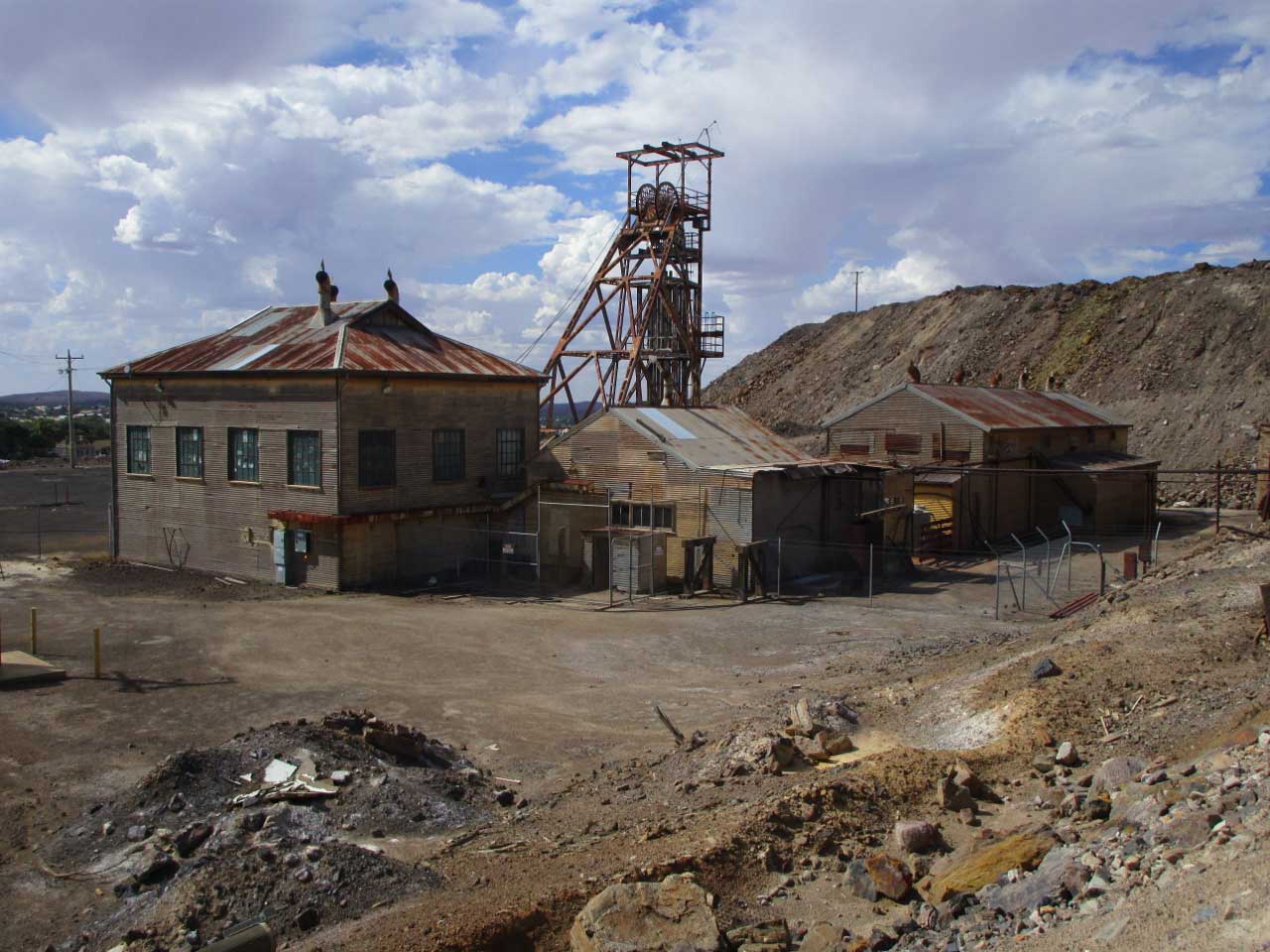 Abandoned mine buildings surrounded by piles of tailings