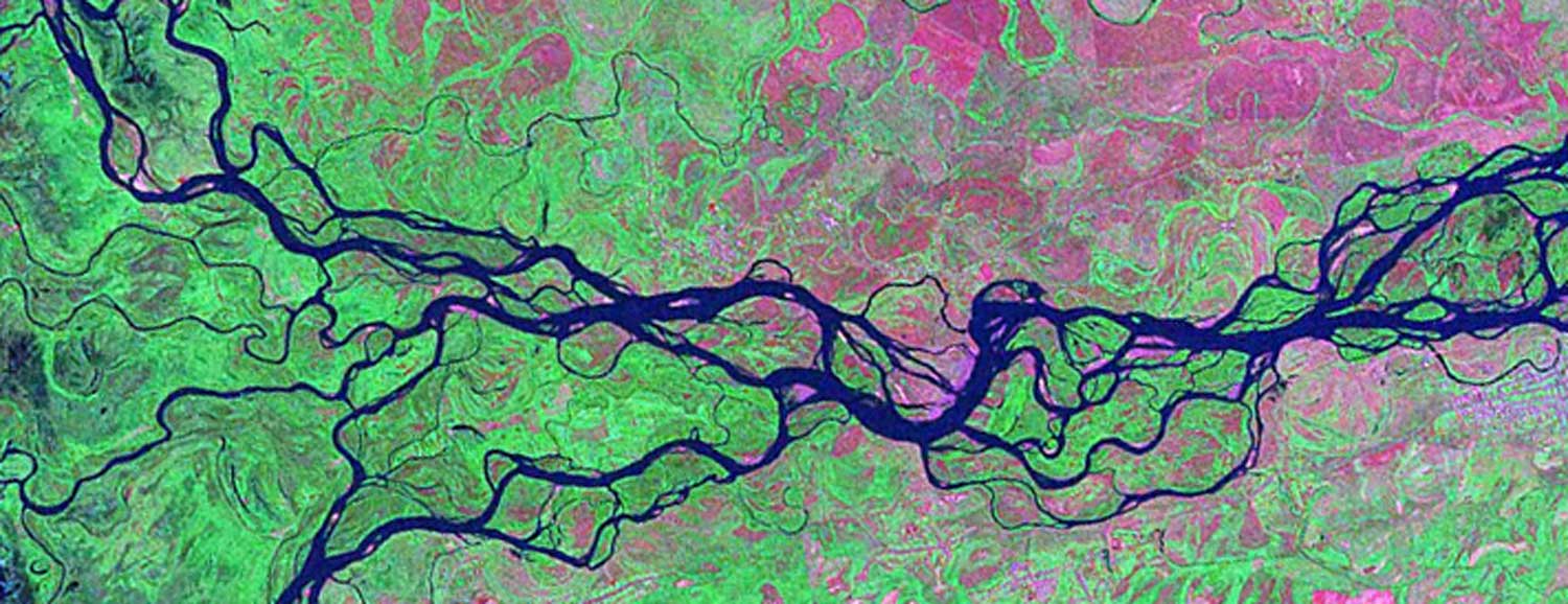 Brightly colored satellite view of a river forming braids of channels