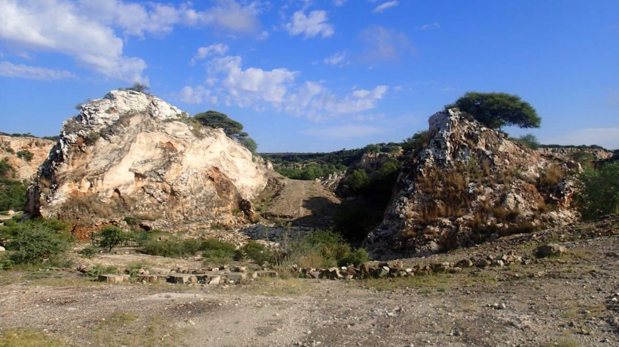 Two hummocks of rock with bare landscape around them